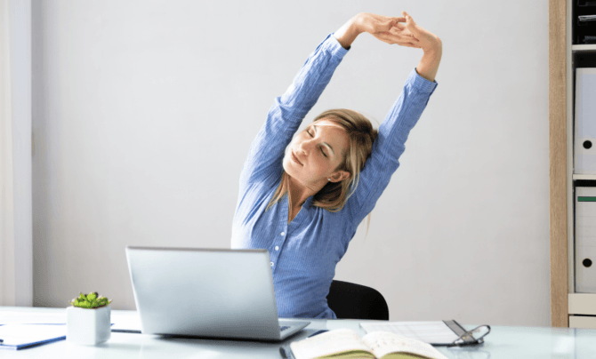 woman stretching at desk